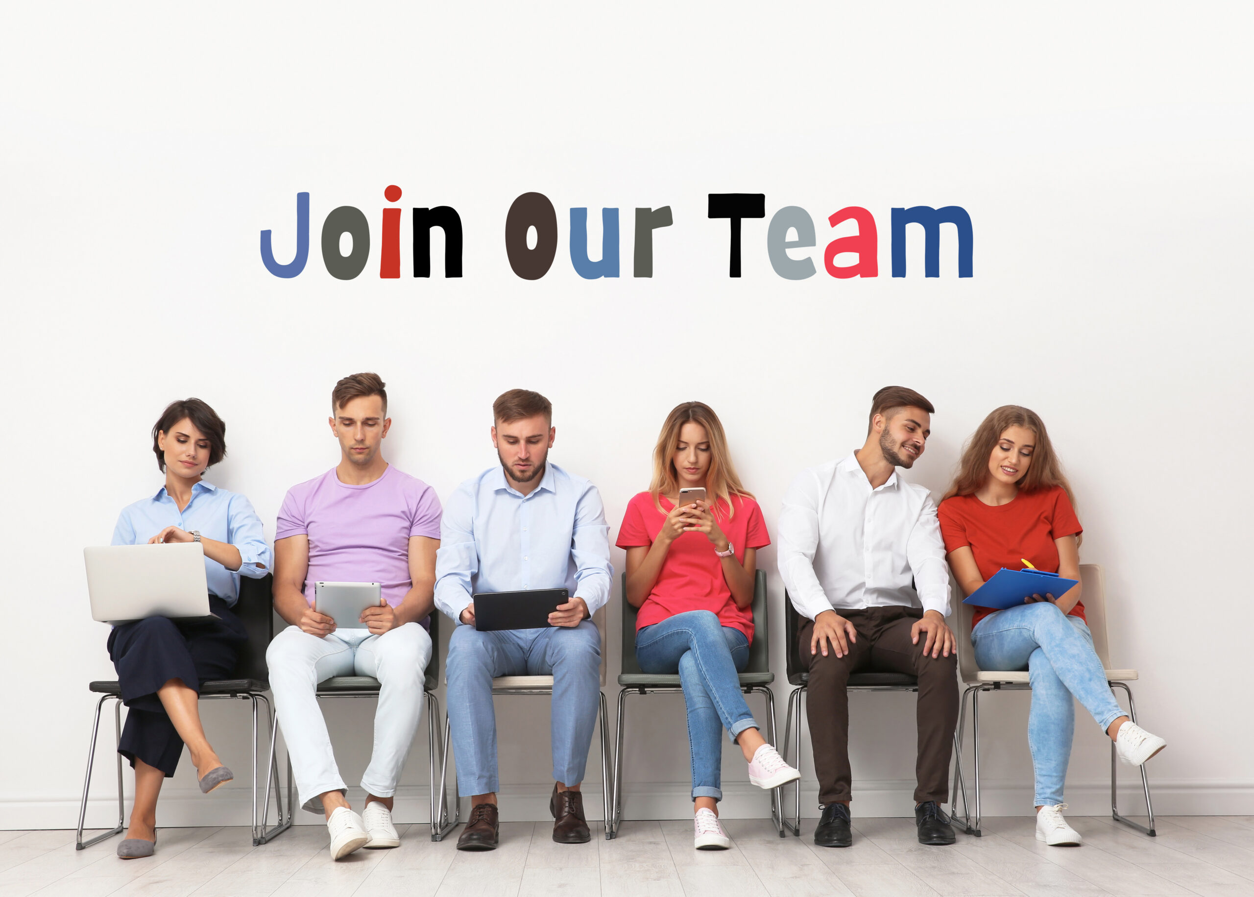 Join Our Team. Group of young people waiting for job interview near light wall. Recruitment, human resource concept